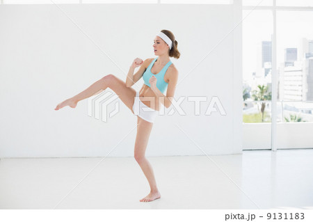 Sporty slim woman doing sports in sports hall Sporty slim woman doing sports in sports hall 9131183