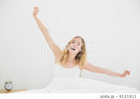 Pretty peaceful blonde sitting in bed yawning Pretty peaceful blonde sitting in bed yawning 9131911