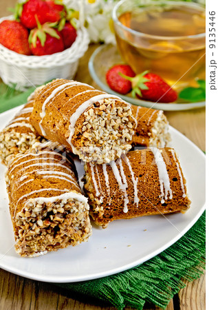 Cookies honey with strawberry and tea on board Cookies honey with strawberry and tea on board 9135446