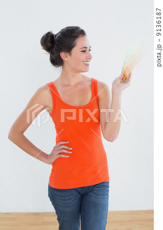 Woman choosing color for painting a room Woman choosing color for painting a room 9136187