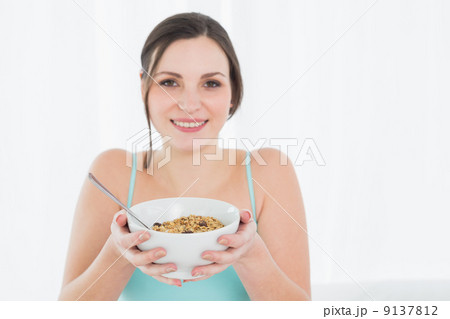 Close-up portrait of a young female with a bowl of cereal 9137812