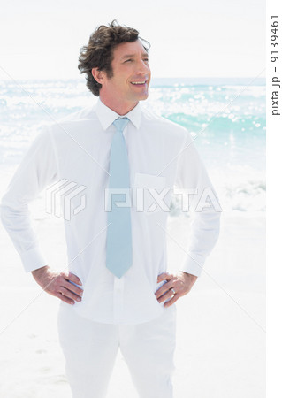 Handsome groom smiling with hands on hips Handsome groom smiling with hands on hips 9139461