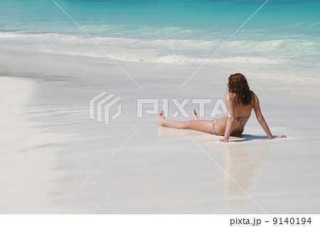 women sunbathing on beach 9140194