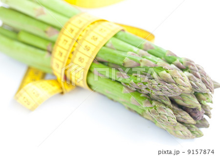 asparagus tied with measuring tape isolated on white 9157874
