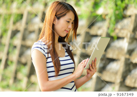 young asian woman with tablet computer outdoor young asian woman with tablet computer outdoor 9167349