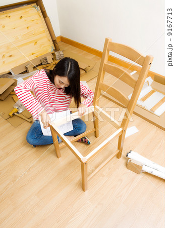 Asian woman using strew driver for chiar assembling 9167713