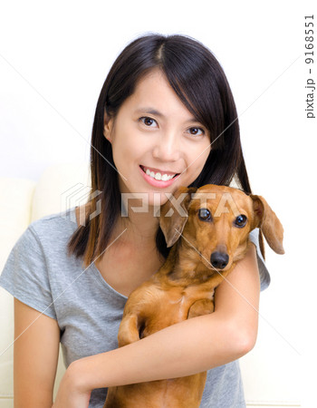 Asian woman with dachshund dog 9168551