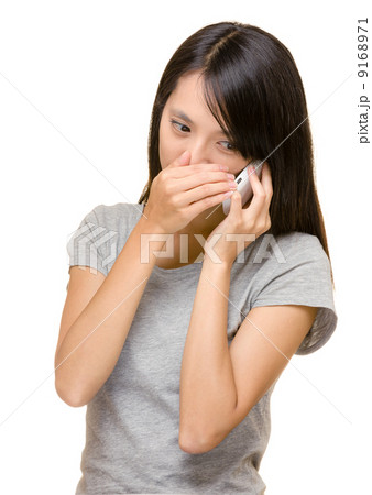 Asian woman talking phone secretly Asian woman talking phone secretly 9168971