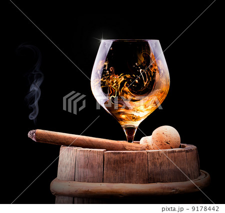 Cognac and Cigar on black with vintage barrel 9178442
