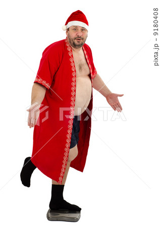 Bearded Santa standing on weight scales Bearded Santa standing on weight scales 9180408