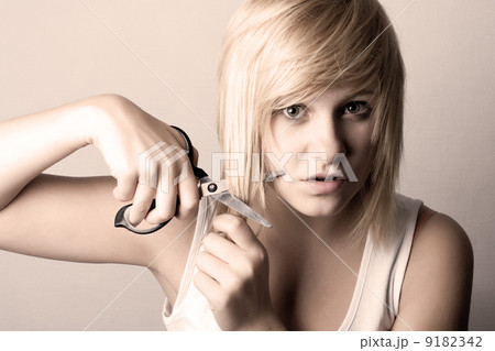 young woman with scissors young woman with scissors 9182342