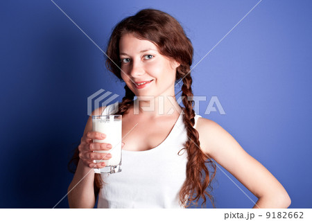 woman enjoying a glass of milk woman enjoying a glass of milk 9182662