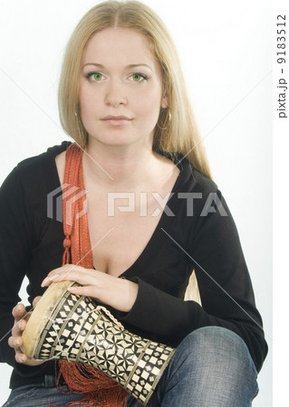 green-eyed pretty blonde with djembe 9183512