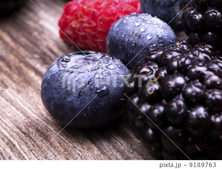 tasty summer fruits on a wooden table 9189763
