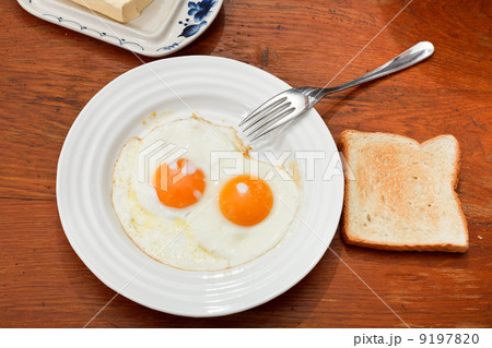 breakfast with two fried eggs in white plate breakfast with two fried eggs in white plate 9197820