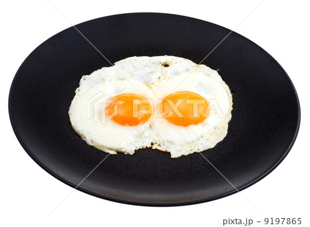 fried eggs on ceramic black plate 9197865