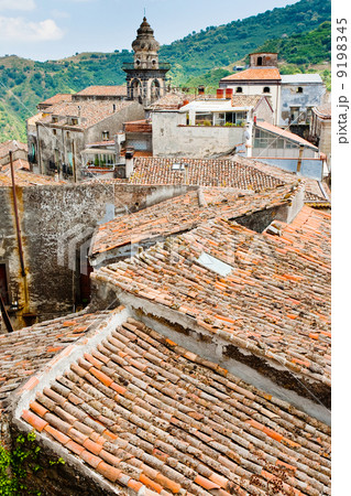 view on ancient tile roofs and church tower in sicilian town 9198345