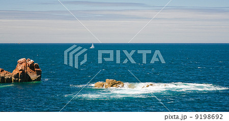 view on sea with pink rocks and yacht 9198692