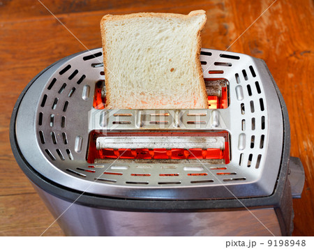 fresh slice of bread on hot metal toaster 9198948