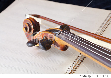 violin bow and scroll on music book violin bow and scroll on music book 9199174