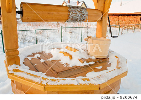 closed woody draw well with bucket in winter 9200674