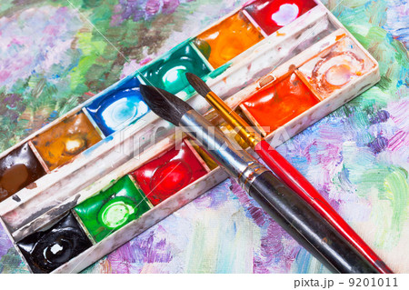 watercolor set and brushes on oil picture background 9201011