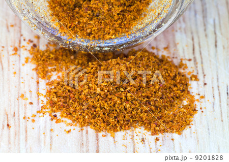 cayenne pepper spilled from glass jar 9201828