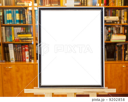 white canvas of picture frame on easel in library white canvas of picture frame on easel in library 9202858