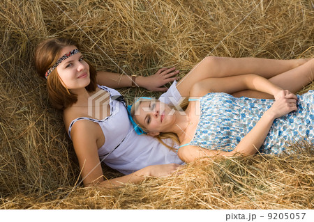 country girls resting on hay country girls resting on hay 9205057