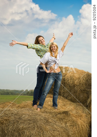 girls standing on hay girls standing on hay 9205084