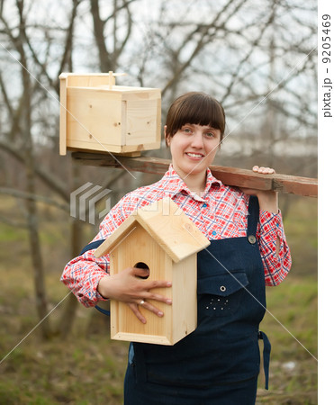 Woman with two birdhouses Woman with two birdhouses 9205469