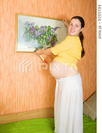 pregnant woman decorating room with picture pregnant woman decorating room with picture 9205594