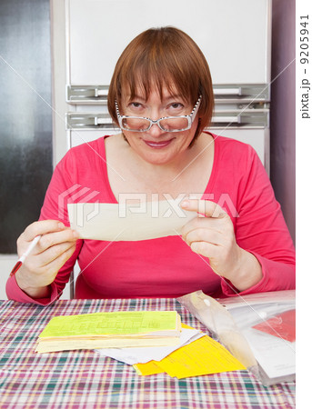mature woman with utility bills 9205941
