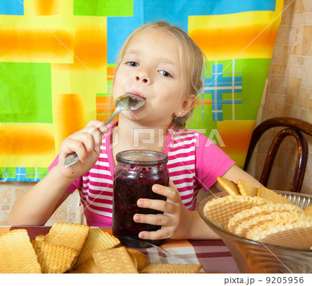 Little girl eating marmalade 9205956