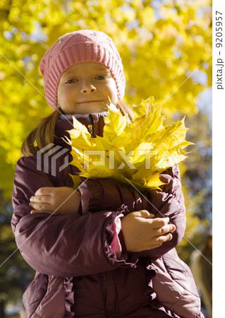 girl with autumn leaves outdoors 9205957