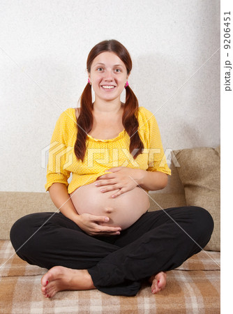 pregnant woman sitting on sofa pregnant woman sitting on sofa 9206451