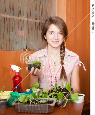 Girl with various seedlings at home Girl with various seedlings at home 9207376