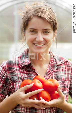 girl with tomato in greenhouse girl with tomato in greenhouse 9207392