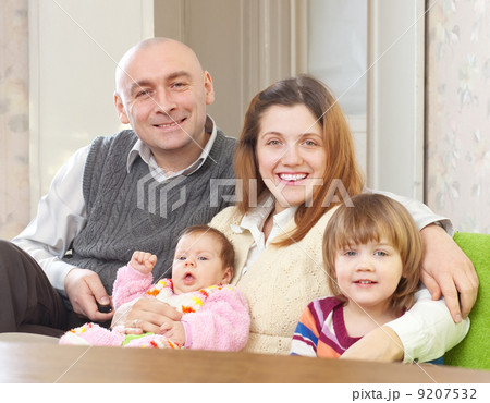 joyful parents with their two kids joyful parents with their two kids 9207532