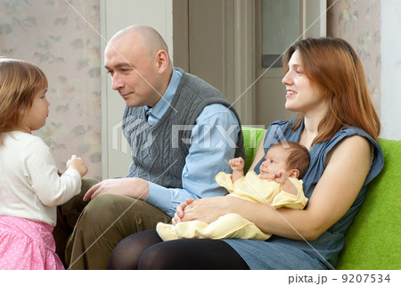 Happy couple with two their children 9207534