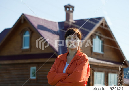 Happy woman against her home Happy woman against her home 9208244