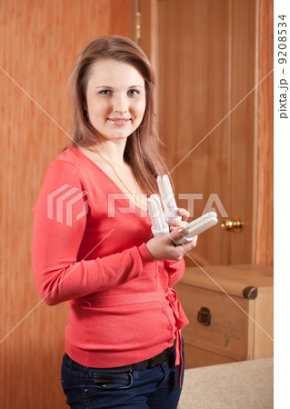 Girl holding energy light bulbs 9208534