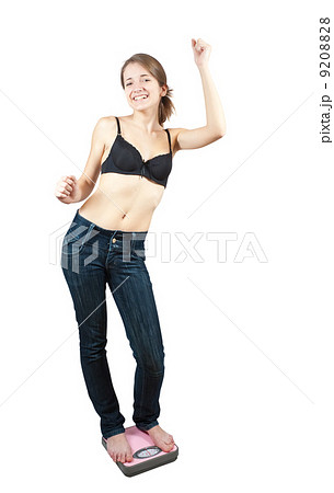 Happy Girl on bathroom scales 9208828