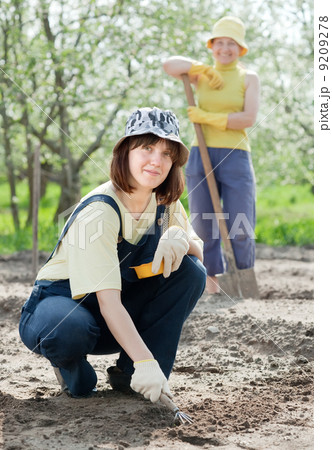 women works at garden in spring women works at garden in spring 9209278
