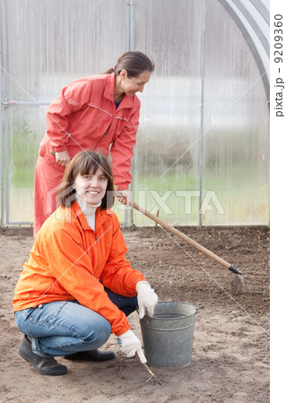 Happy women works at greenhouse Happy women works at greenhouse 9209360