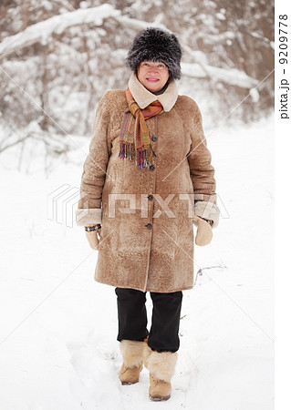 mature woman is walking at winter forest 9209778