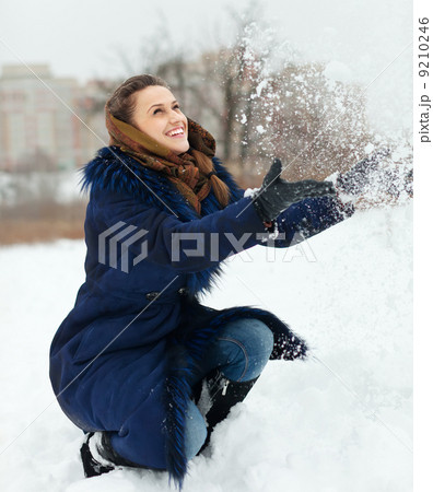 Girl throwing up snowflakes Girl throwing up snowflakes 9210246