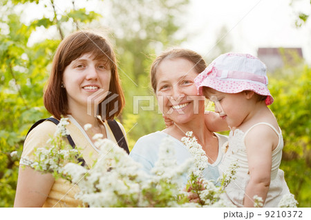 women and kid at summer garden 9210372