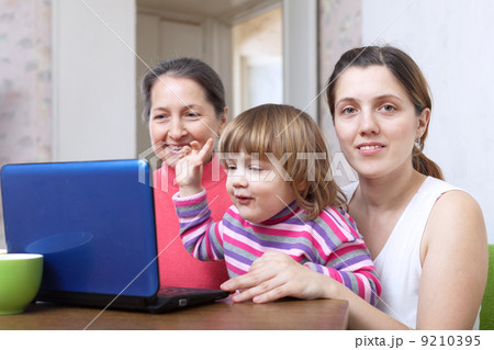 Women of three generations using laptop 9210395