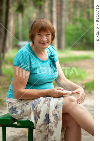 woman embrocating ointment in knee woman embrocating ointment in knee 9210715